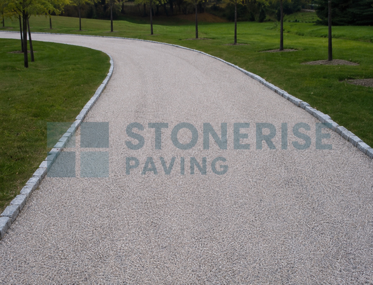 Tar and chip driveway with natural stone finish on a UK residential property